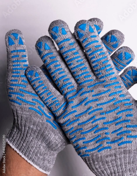 Fototapeta Industrial Protective Gloves with Blue Rubber Grip on White Background