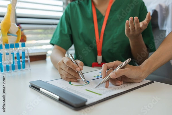 Fototapeta consultation between two doctors in the office, two medical students are discussing treatment guidelines for a patient assigned to them by a senior physician, nurse, brainstorming, hospital
