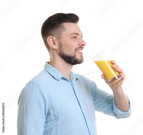 Fototapeta Handsome man posing with juice on white background
