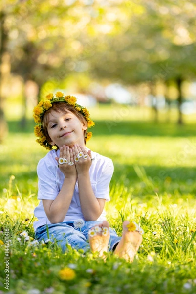 Obraz Portrait of cute stylish smiling toddler boy sitting in the grass in park