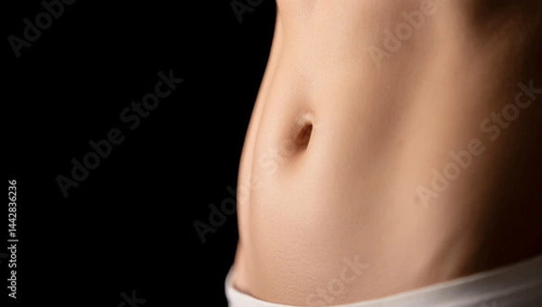 Fototapeta close-up of a woman’s abdomen and side