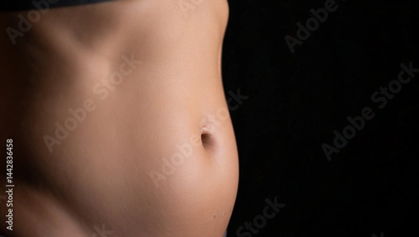 Fototapeta close-up of a woman’s abdomen and side