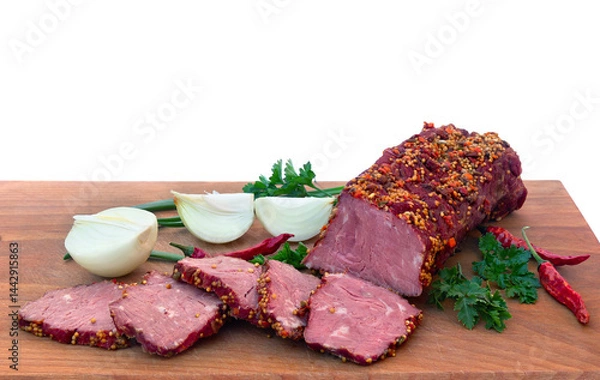 Fototapeta Smoked beef with pieces and spice, red chilli pepper, bulb onion and green leaves onion and parsley on wooden cutting board on a white background with space for text. Top view, flat lay