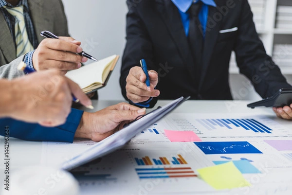 Obraz Business team analyzing chart and graph. Businesspeople corporate meeting, reviewing data financial report and marketing research. Discussing market situation analysis and financial planning.