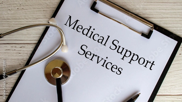 Fototapeta Top view of Medical Support Services text on clipboard with gavel on top. Medical support concept