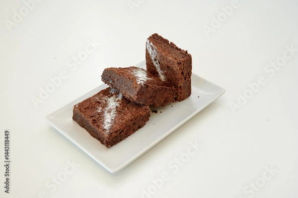 Obraz A plate of brownies with white frosting. The frosting is in the shape of a diamond