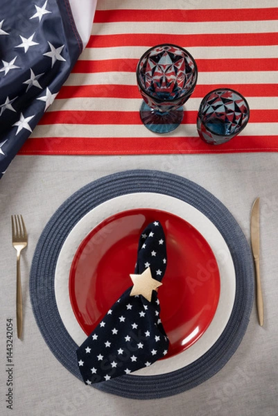 Obraz Table setting for USA Independence Day. Festive dinner with red plate and decoration in USA national flag colors and stars. Copy space. Vertical. View from above