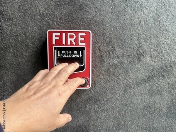 Fototapeta A hand was pulling down the fire call to fire alarm.