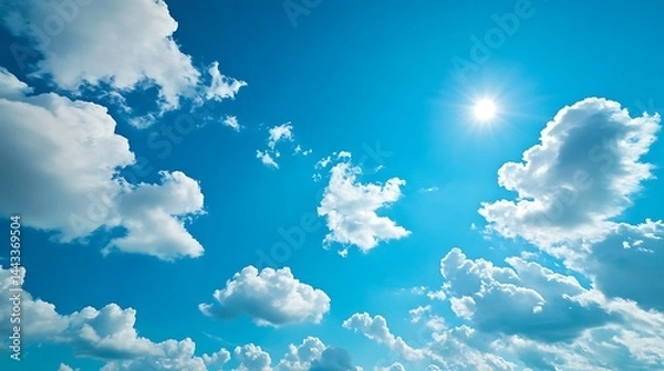 Fototapeta Bright blue sky with scattered white clouds on a sunny day