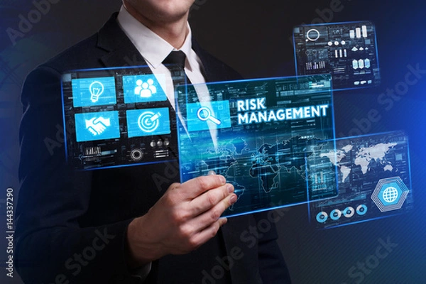 Fototapeta Business, Technology, Internet and network concept. Young businessman working on a virtual screen of the future and sees the inscription: Risk management