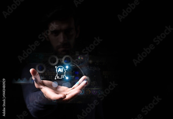 Fototapeta A man presents a glowing AI icon with digital interface graphics, symbolizing artificial intelligence, innovation, and future technology.