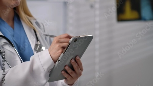Fototapeta Healthcare Professional Using Tablet in Clinical Environment