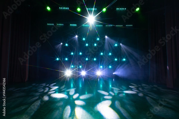 Fototapeta Stage setup with vivid green and yellow LED lights and strong lens flares, creating a radiant and immersive atmosphere with beam effects and colorful reflections on the floor.