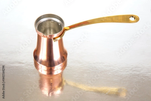 Obraz Close-up of a traditional copper Turkish coffee pot with a long brass handle, isolated on a white background, perfect for cultural beverage themes