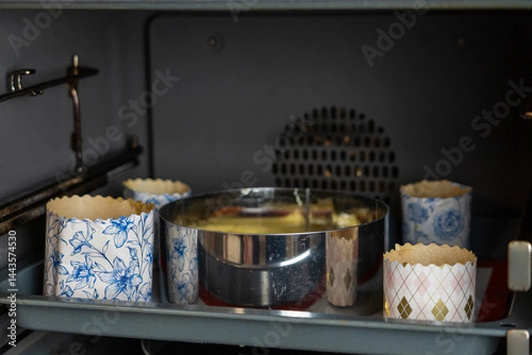 Obraz Pastry preparation: Baking dough for cupcakes and cake in the oven, ready for Easter celebration or birthday treat