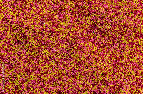 Fototapeta Multicolored background from sugar powder for Easter.