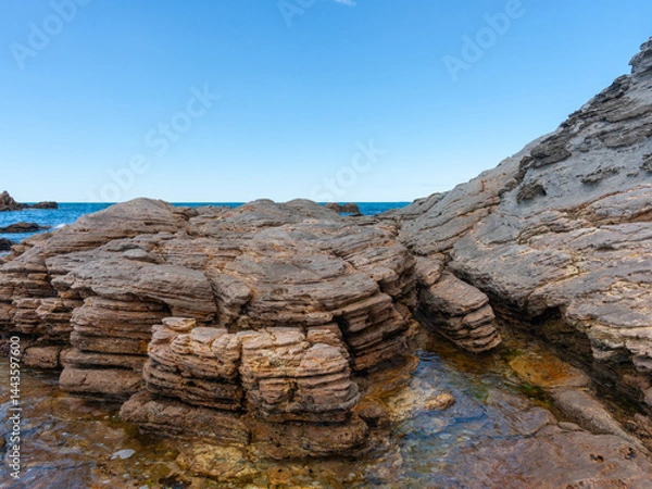 Fototapeta Weathered rocks and rock-pools at base of Mount Maunganui
