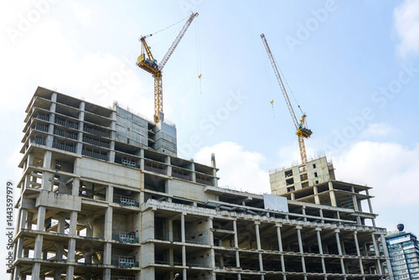 Fototapeta Construction of a new reinforced concrete high-rise building, unfinished building frame