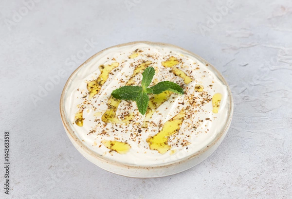Obraz Close up of labneh yogurt cheese with olive oil, za'atar and fresh mint. Middle Eastern food.