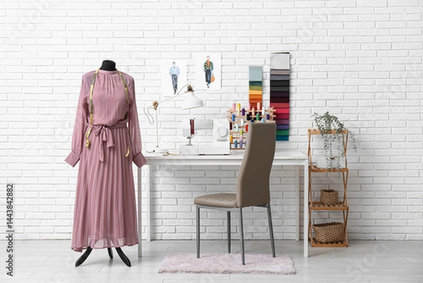 Fototapeta Interior of atelier with tailor's workplace, drawings and mannequin
