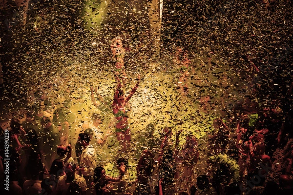 Fototapeta Night club dj party people enjoy of music dancing sound with colorful light with Smoke Machine and lights show. Hands up in the earth.