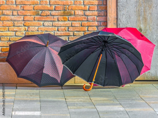 Fototapeta Colorful umbrellas are dried in the walls of the house on the island of Burano - Venice, Italy