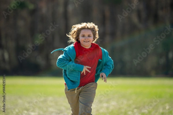 Fototapeta Child run fast in park. The child runner run and sprint outdoors. Kid run with fun. Outdoor sports kids healthy. A child runs through nature. The run motion of carefree kid. Running and jogging kids.