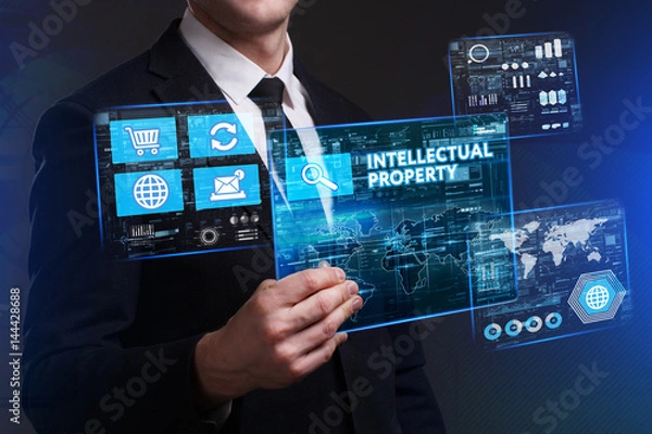 Fototapeta Business, Technology, Internet and network concept. Young businessman working on a virtual screen of the future and sees the inscription: Intellectual property