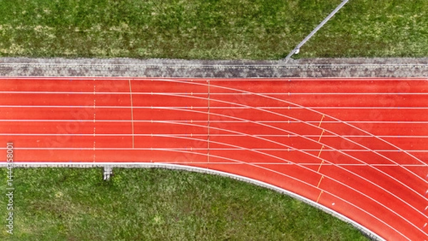 Fototapeta Running track aerial drone view background from above, athletic stadium with track lines bird’s view, sport and fitness infrastructure in the Netherlands