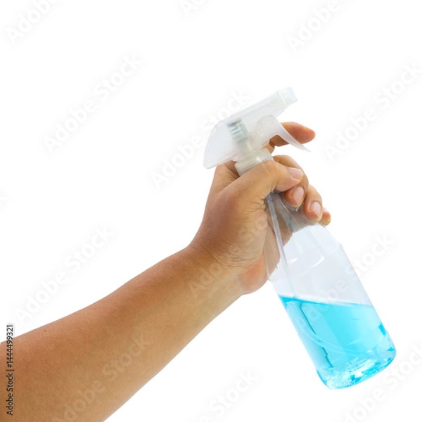 Obraz Hand holding alcohol spray bottle for cleaning and sanitizing surfaces in various locations