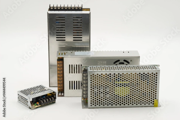 Obraz Multiple size of switching power supplies isolated on white background for electronics tasks