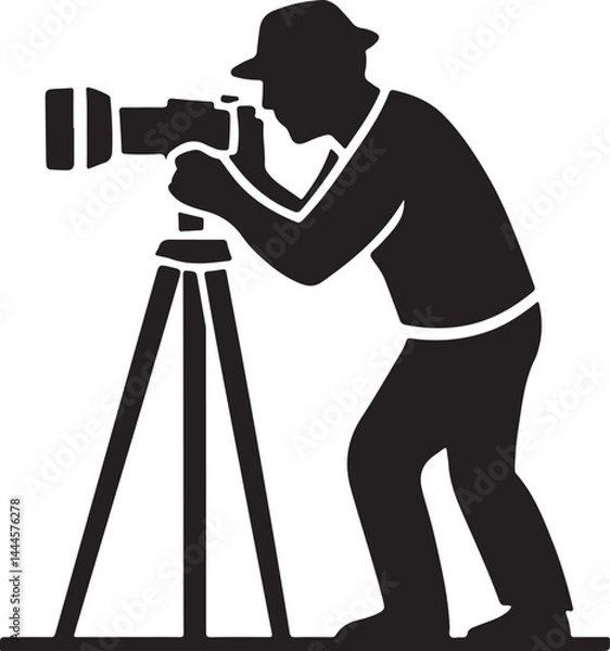 Fototapeta A professional photographer's silhouette with a camera on a tripod captures a photo
