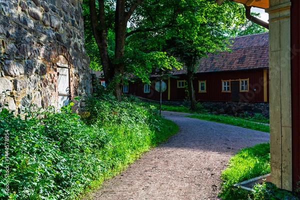 Fototapeta Buildings and Rustic Pathway Near Gothenburg Surrounded by Lush Greenery