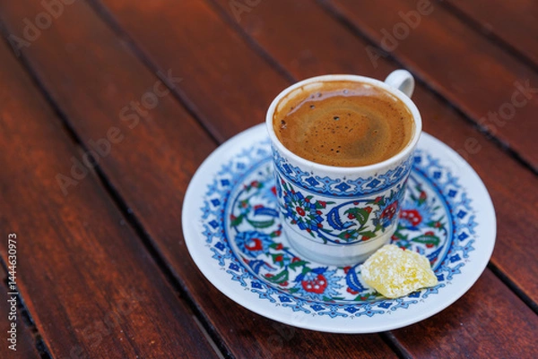 Fototapeta Traditional delicious Turkish coffee or Greek coffee with foam in ornate cup on wooden table
