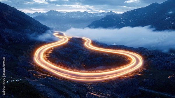 Fototapeta Winding mountain road illuminated by car lights in long exposure at dusk, symbolizing journey and persistence. 