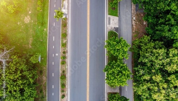 Fototapeta A safe road with signs, sidewalks, and trees, top-down perspective