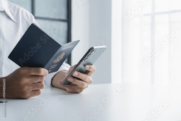 Obraz hand hold passport for online booking and buy ticket on mobile phone