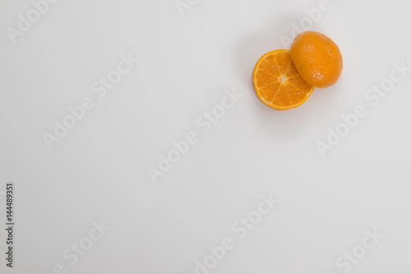 Fototapeta Cut Orange in Corner on White Background