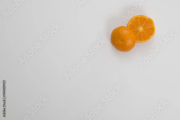 Obraz Cut Orange in Corner on White Background