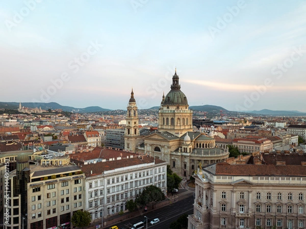 Obraz Timeless elegance of Budapest St. Stephen Basilica crowned by soft golden light, intricate city patterns, endless rooftops, and charming squares create stunning aerial portrait. Travel concept
