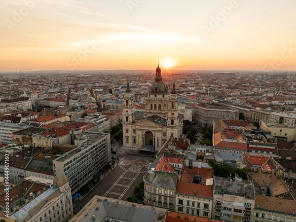 Obraz Dawn over St. Stephen Basilica shines golden sunrise, embraced by red rooftops building, elegant streets, and panoramic city views stretching horizon aerial view