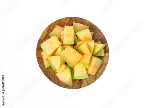 Obraz Fresh melon slices on wooden plate isolated on white background. Healthy food lifestyle, Top view 