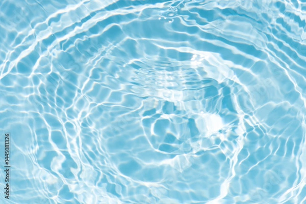 Fototapeta Blue water with ripples on the surface. Defocus blurred transparent blue colored clear calm water surface texture with splashes and bubbles. Water waves with shining pattern texture background.