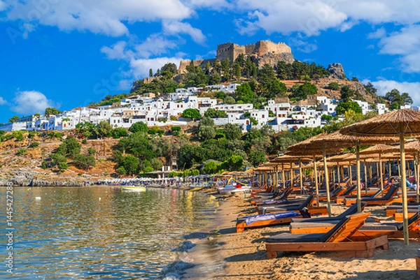 Fototapeta Lindos, Rhodes, Greece: Scenic view of Lindos Acropolis and beach on Rhodes island, Aegean Sea