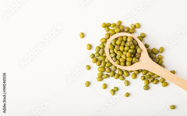 Fototapeta Raw mung beans or dal in  wooden spoon on white background isolated, top view with copy space