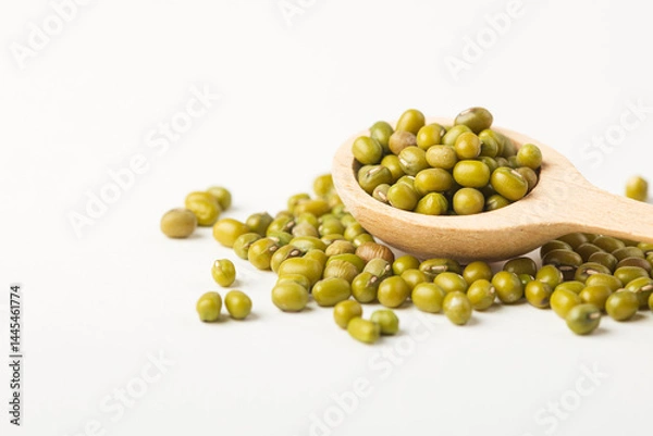 Fototapeta Raw mung beans or dal in  wooden spoon on white background isolated with copy space