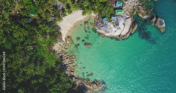 Obraz Aerial view of a tropical beach landscape with lush greenery, white sandy shore, turquoise water waves surrounded by rocks. Nature vacation concept. Thailand, Koh Phangan Island, Haad Thong Reng Beach