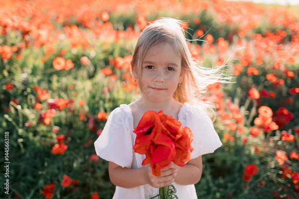 Obraz Little child girl in flowered poppy field. Child in white dress with red flowers in summer