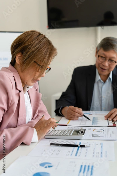 Obraz Senior businessmen calculating investment.
