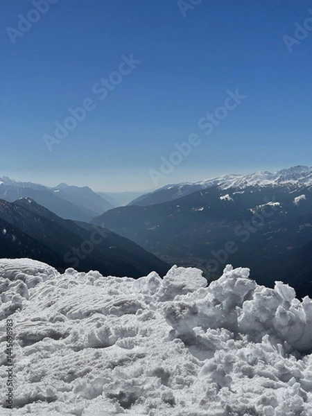 Fototapeta The Breathtaking SnowCapped Mountains Stand Majestically Under a Clear Blue Sky Above